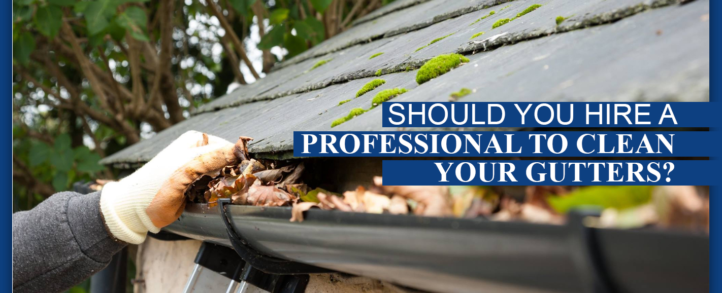 hand cleaning gutter full of leaves
